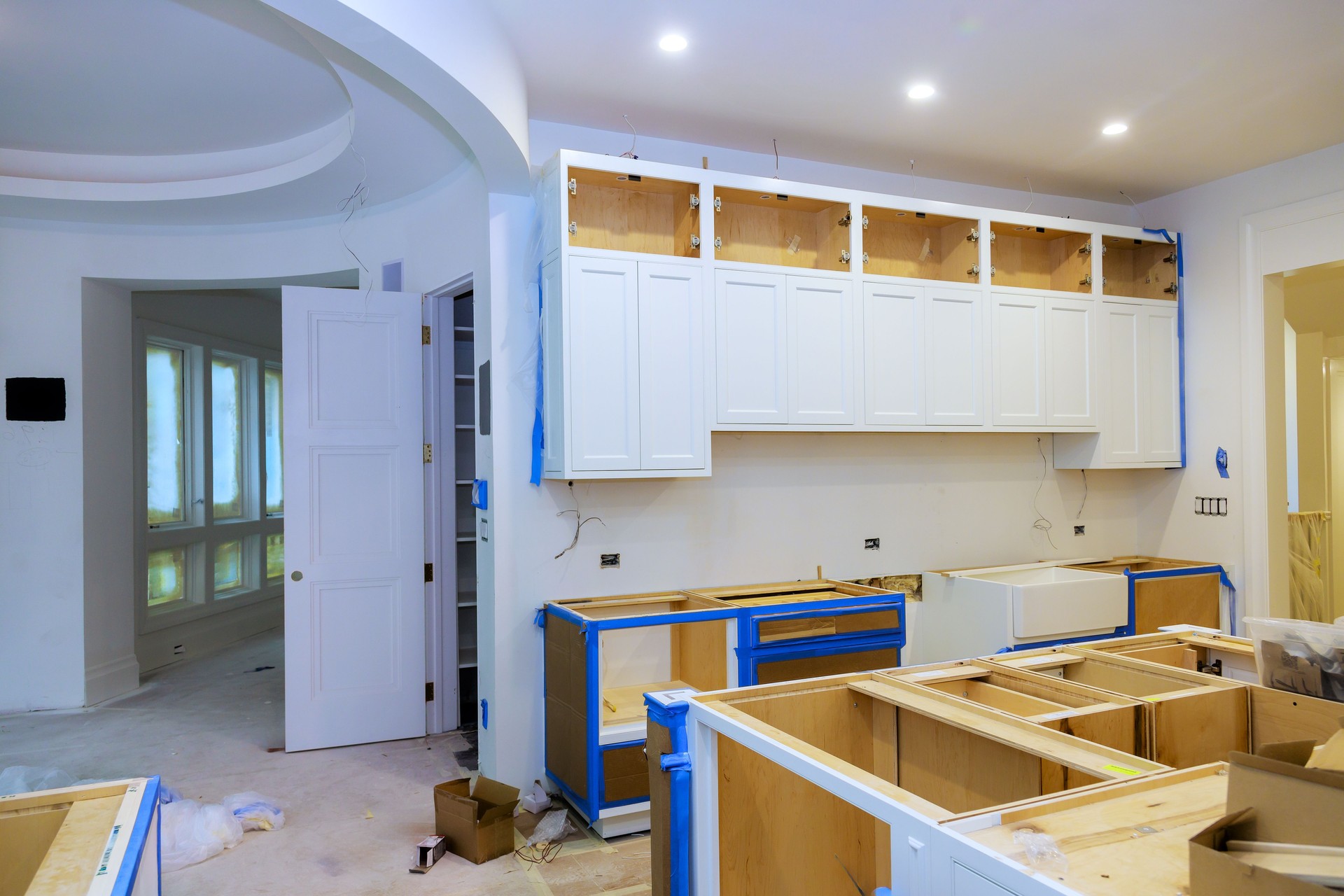 Modern kitchen renovation in progress with cabinetry installation and open layout design